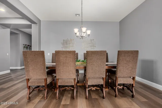 a view of a kitchen with stainless steel appliances granite countertop a refrigerator and a stove top oven
