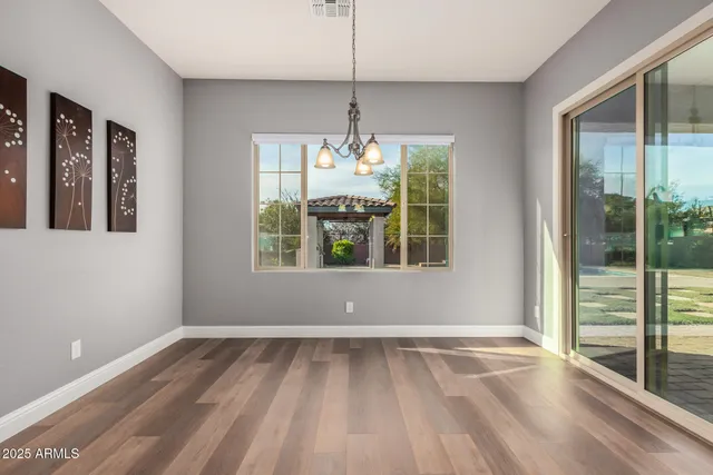 a kitchen with stainless steel appliances granite countertop a lot of counter space and wooden floor