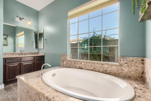 a view of a livingroom with a ceiling fan & hardwood floor