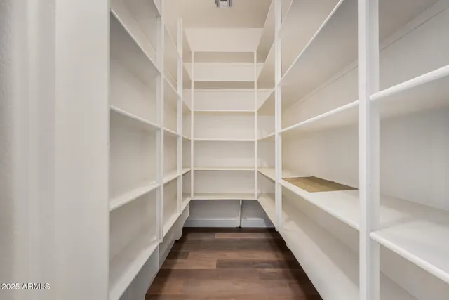 a view of a livingroom with a ceiling fan and wooden floor