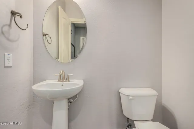 a bathroom with a granite countertop sink and a large mirror