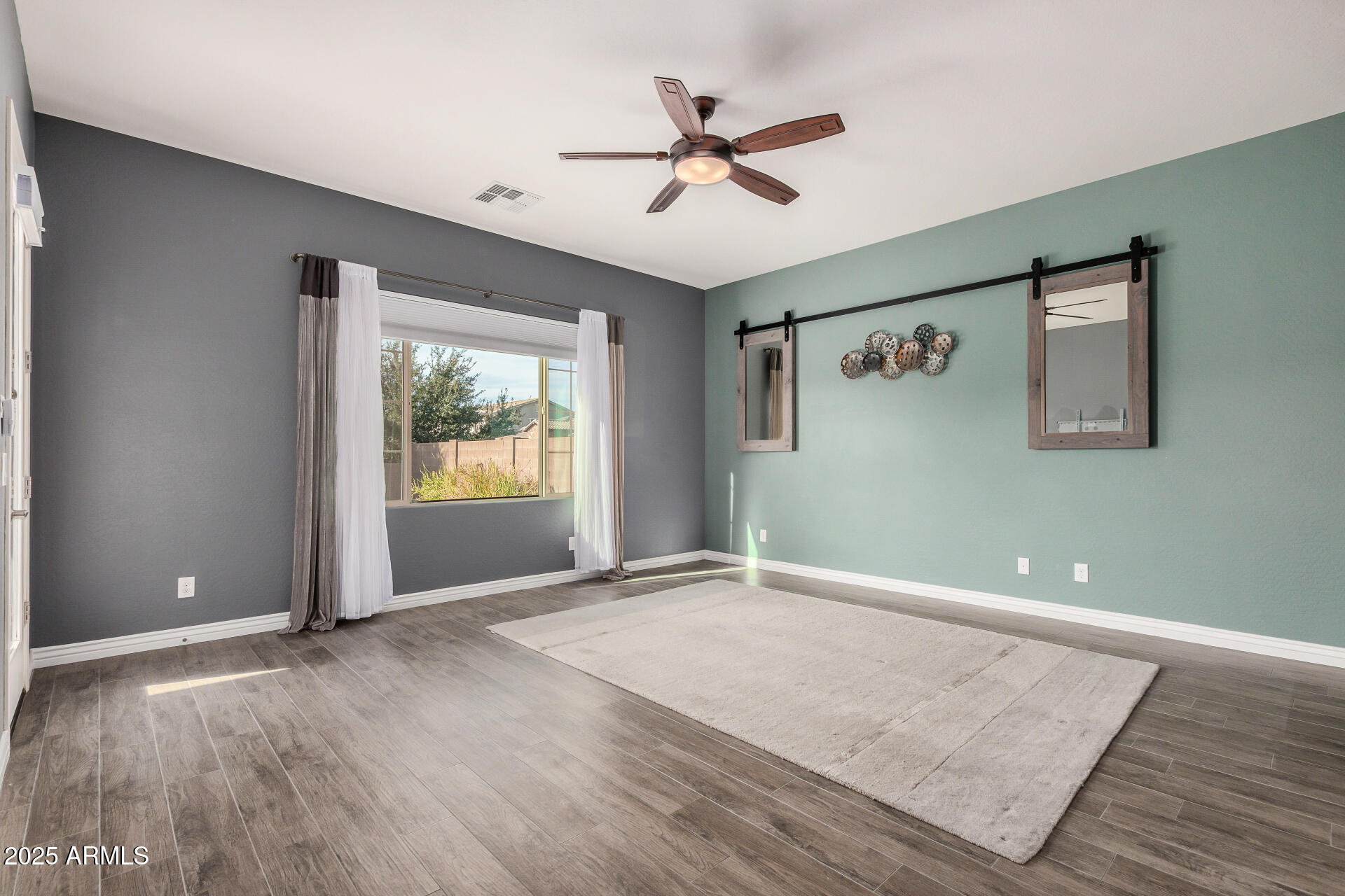 1672 South Sunset Drive Chandler, AZ 85286 - Photo 23 of 68 wooden floor in an empty room with a window