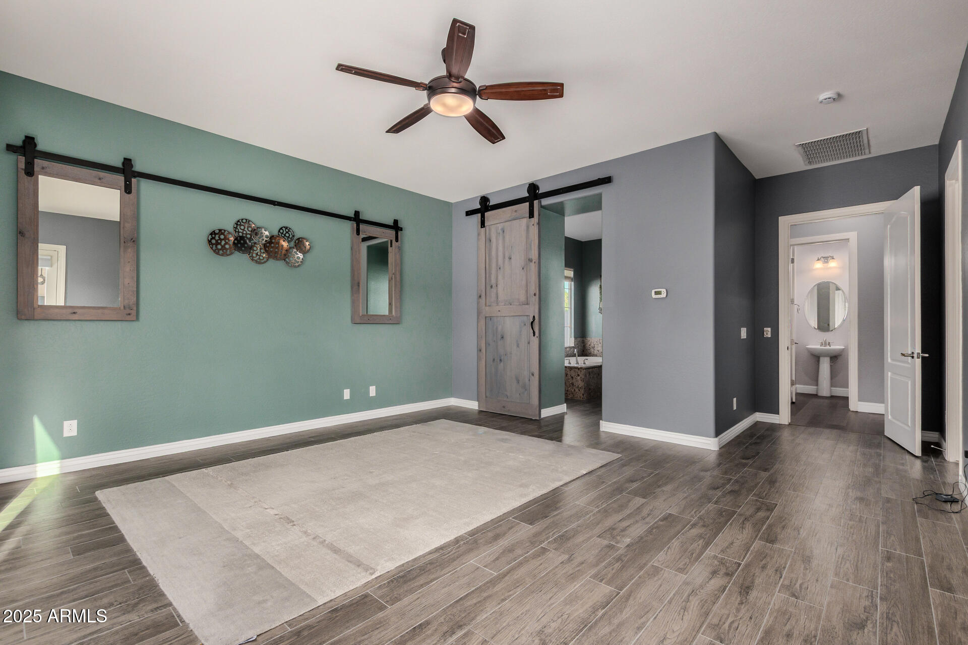 1672 South Sunset Drive Chandler, AZ 85286 - Photo 24 of 68 a view of a livingroom with a ceiling fan & hardwood floor