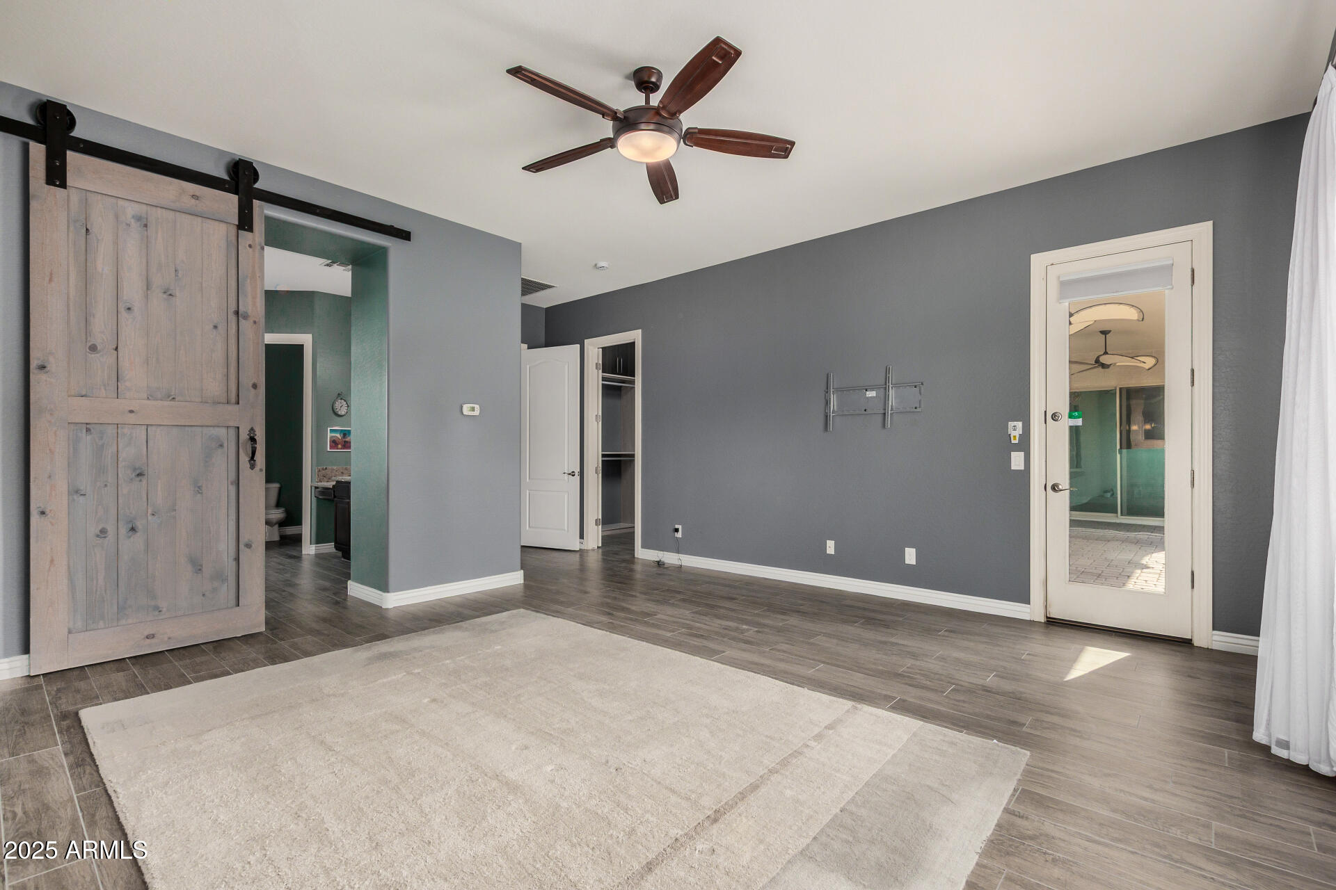 1672 South Sunset Drive Chandler, AZ 85286 - Photo 25 of 68 a view of a livingroom with a ceiling fan and wooden floor
