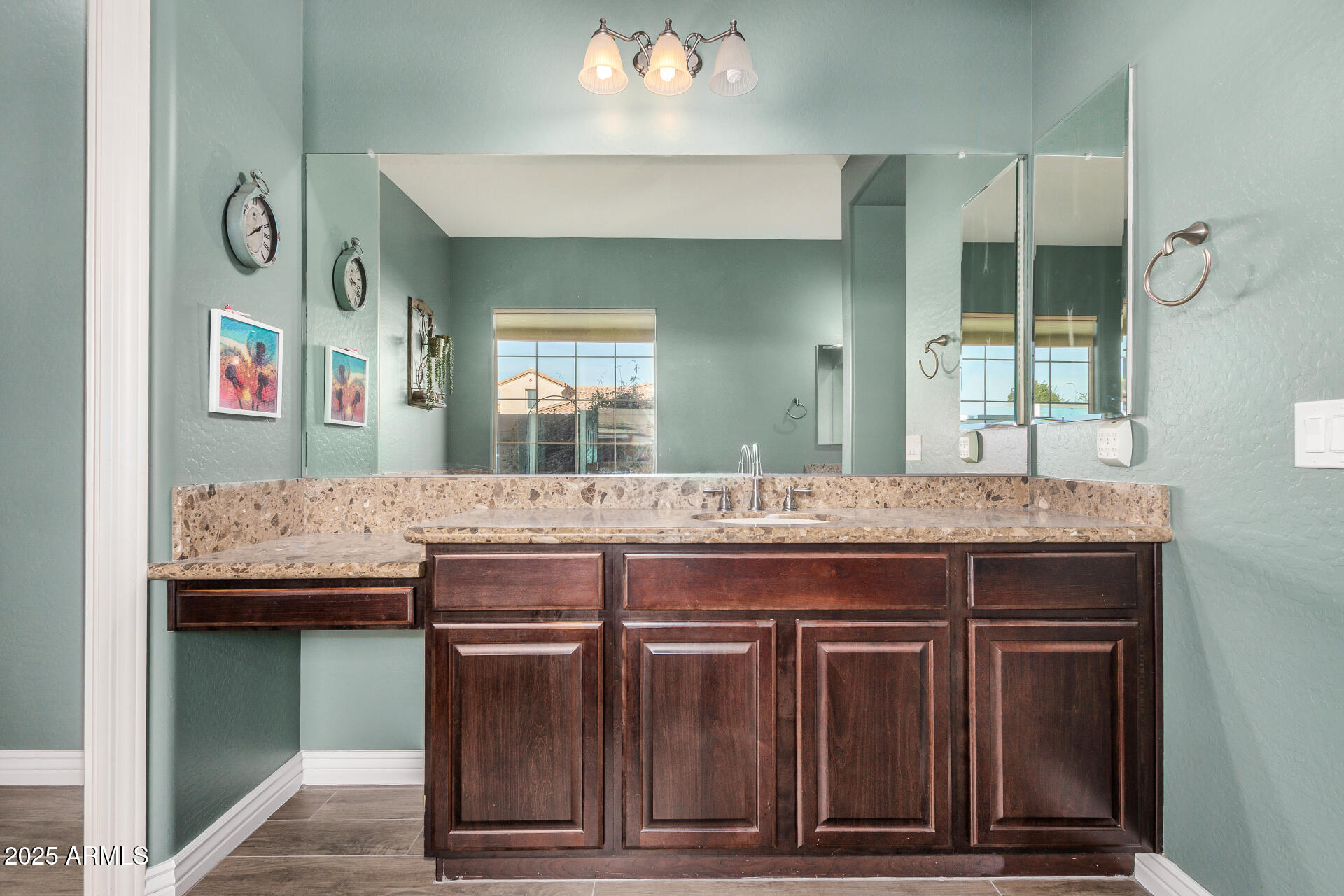 1672 South Sunset Drive Chandler, AZ 85286 - Photo 26 of 68 a bathroom with a granite countertop sink and a large mirror
