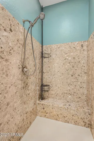 a bathroom with a granite countertop sink a toilet and a large mirror