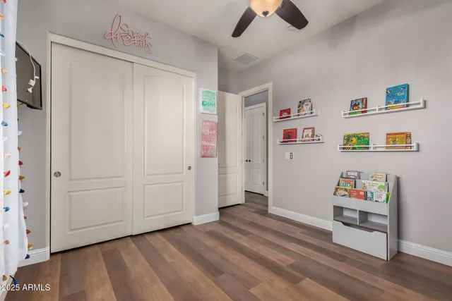a view of swimming pool with lawn chairs and potted plants