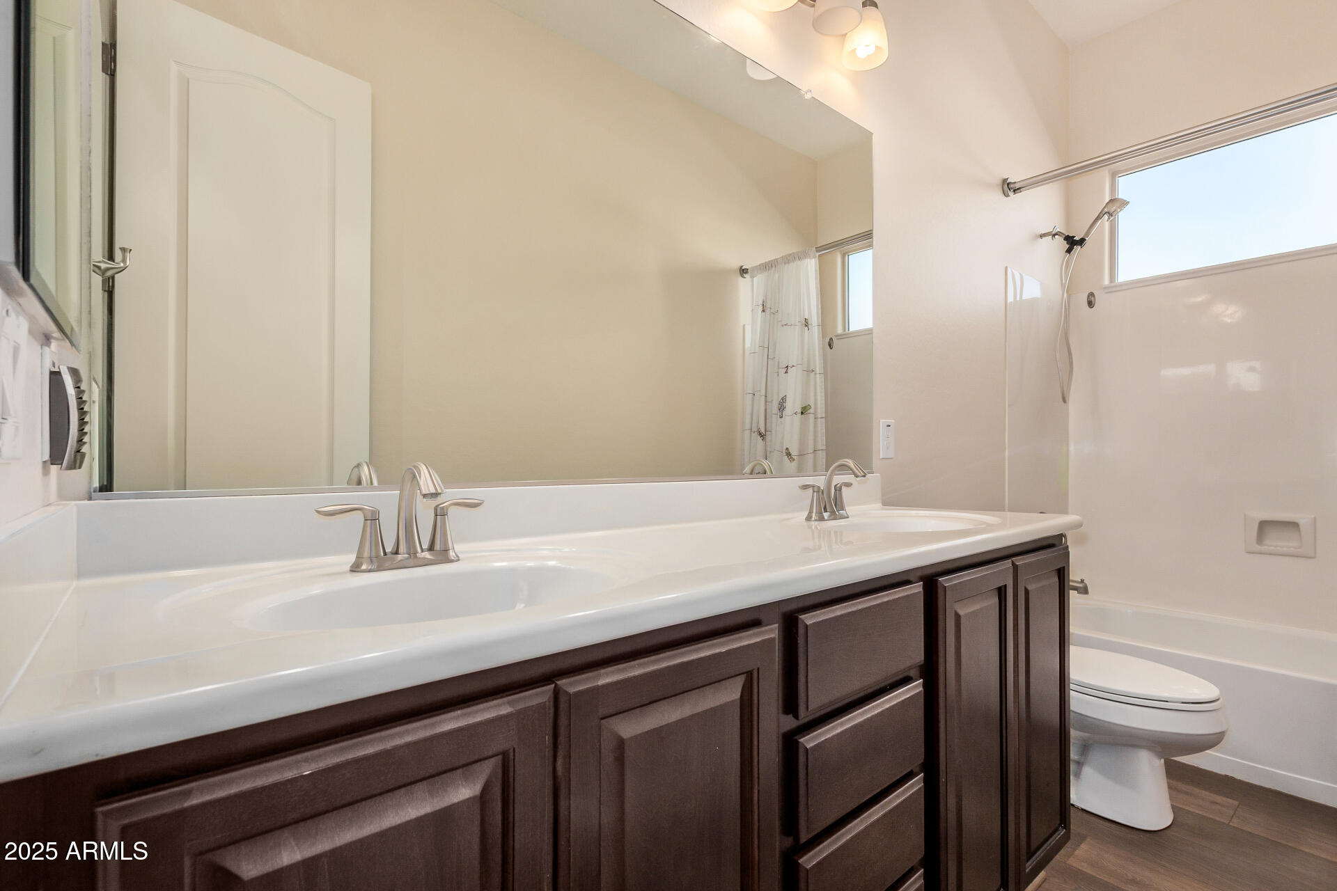 1672 South Sunset Drive Chandler, AZ 85286 - Photo 35 of 68 a bathroom with a granite countertop sink a toilet and a large mirror