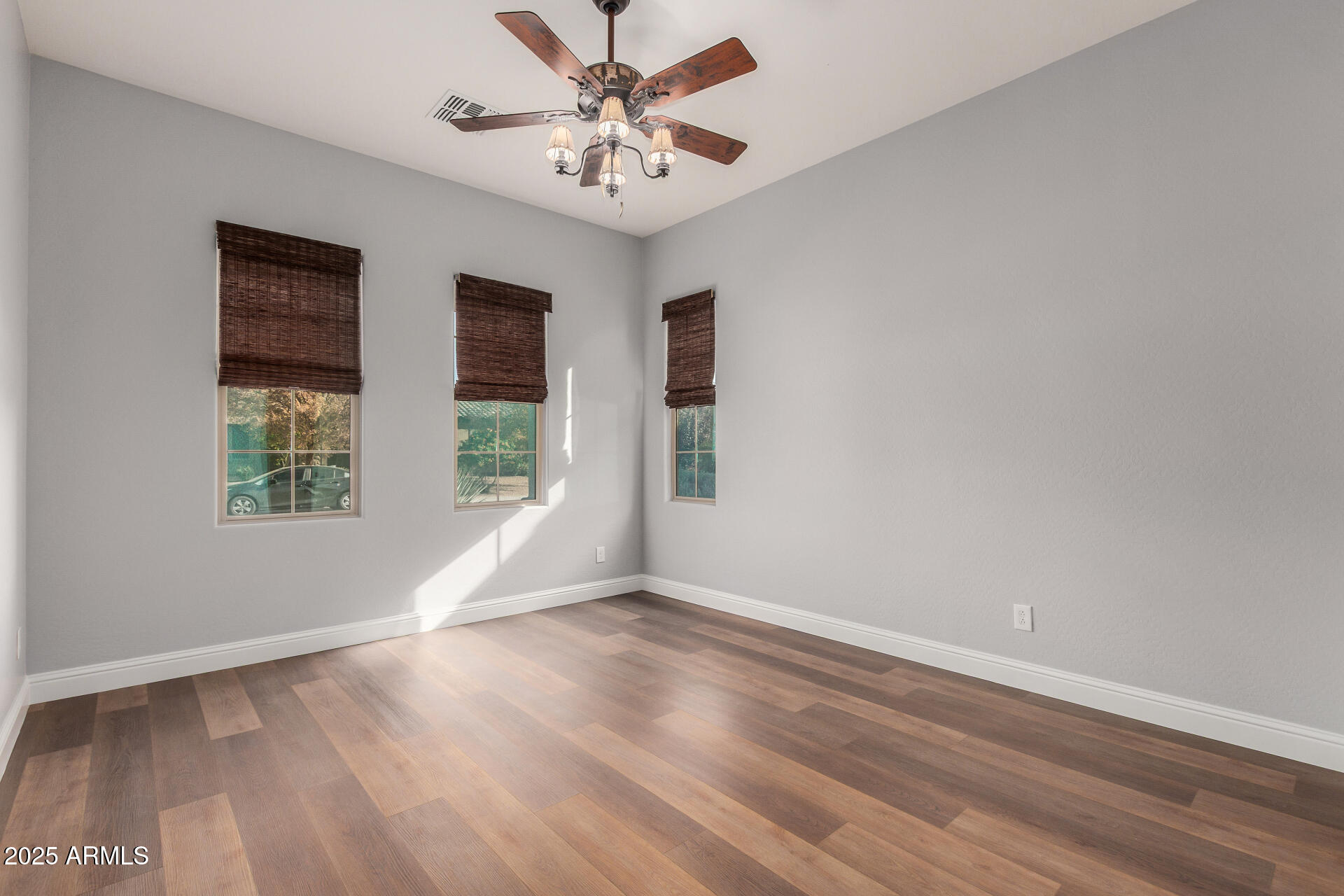 1672 South Sunset Drive Chandler, AZ 85286 - Photo 36 of 68 a view of an empty room with wooden floor and a window