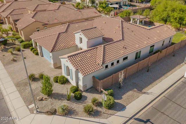 an aerial view of a house with a swimming pool
