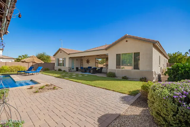 an aerial view of a house with large trees