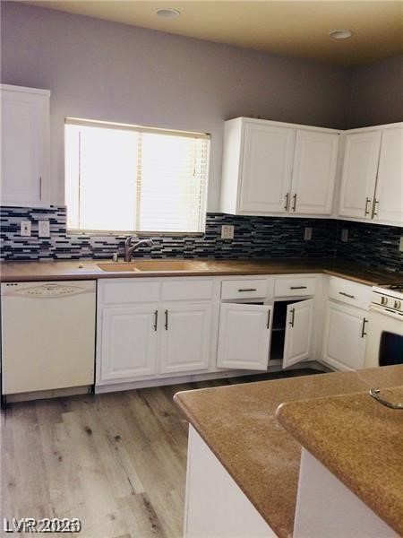 8897 Houston Ridge Avenue Las Vegas, NV 89178 - Photo 5 of 12 A well-appointed kitchen features ample cabinetry and light-colored flooring, complemented by a stylish tiled backsplash.
