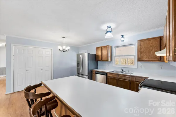 a kitchen with stainless steel appliances a stove a sink and a refrigerator