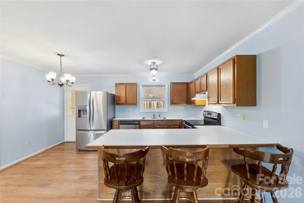 a large kitchen with a table and chairs in it