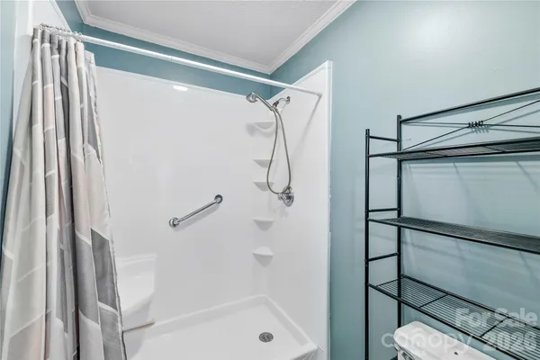 a bathroom with a shower and a glass door