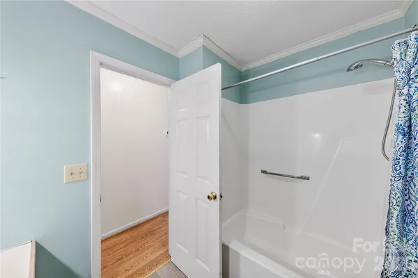 a bathroom with a bathtub and a shower
