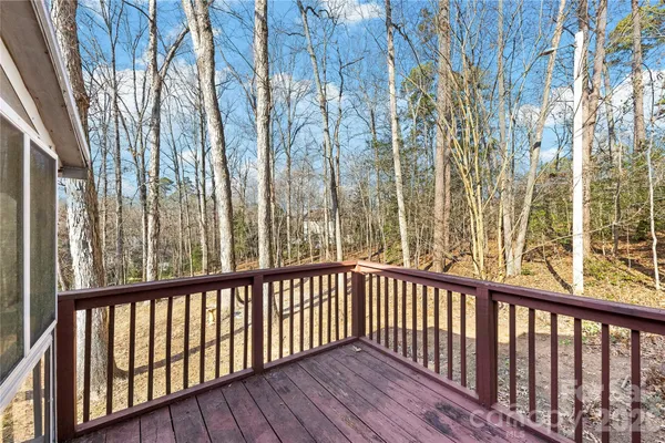 a view of a balcony with wooden floor and fence