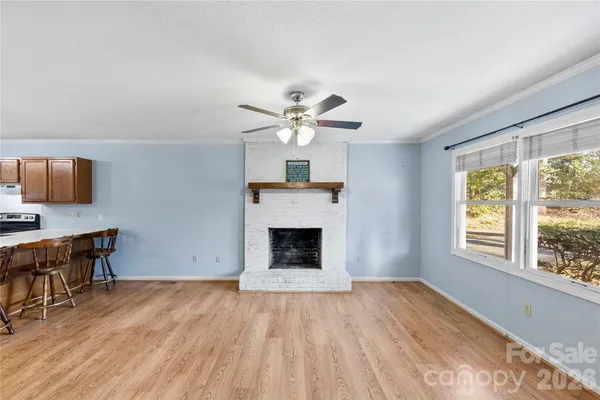 a view of livingroom with window fireplace and wooden floor