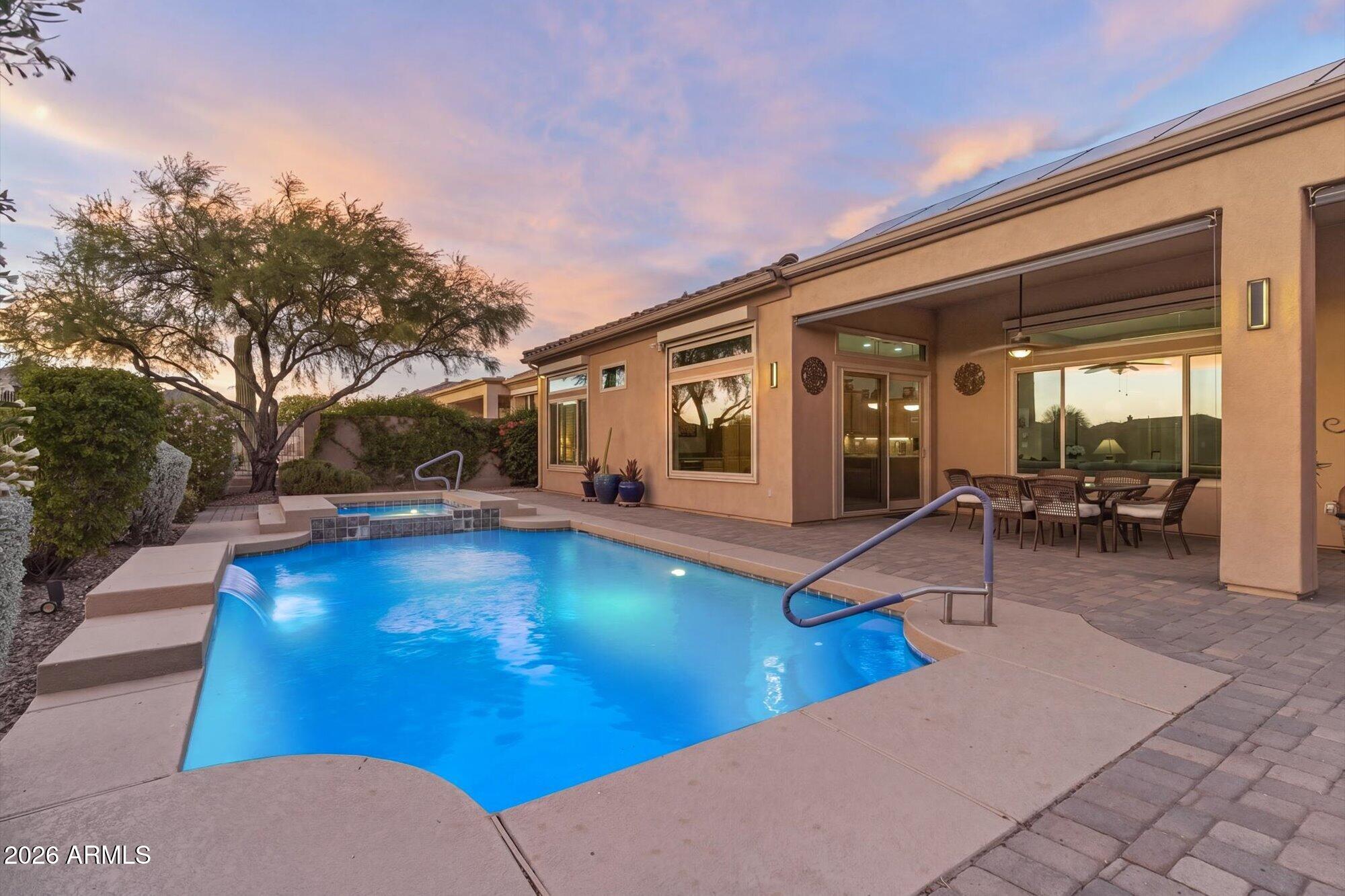 40322 North Hawk Ridge Trail Anthem, AZ 85086 - Photo 16 of 63 a view of a patio with swimming pool table and chairs