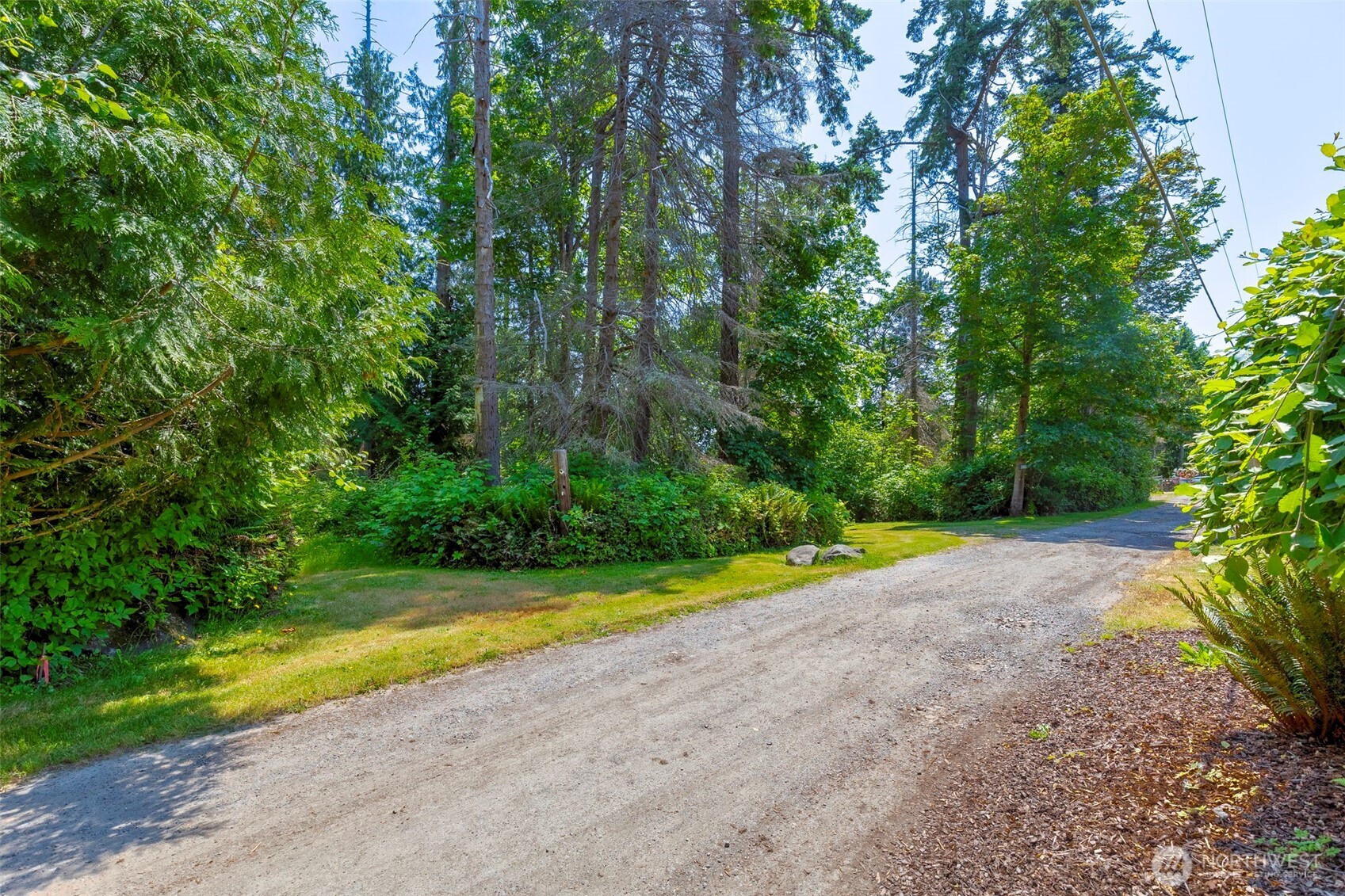 20818 President Point Road Northeast Kingston, WA 98346 - Photo 18 of 36 a view of a swimming pool with a yard and large trees