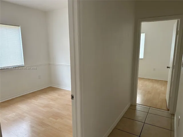 a kitchen with a refrigerator and a microwave