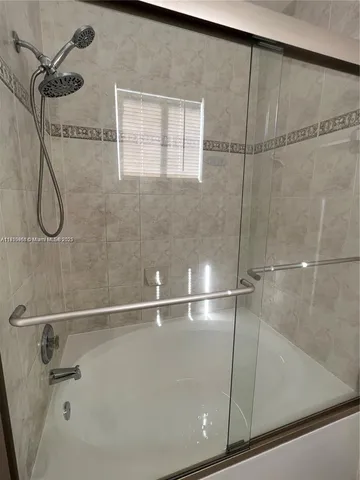 a bathroom with a granite countertop sink and white cabinets