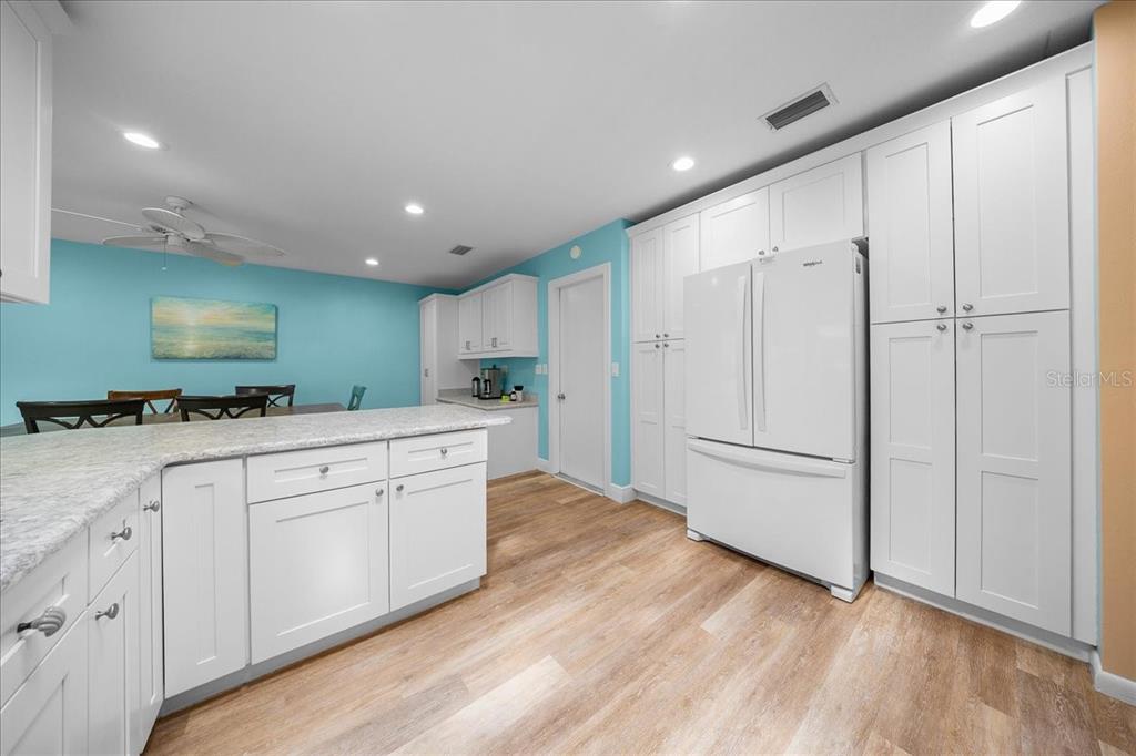 8720 Southwest 90th Street, Unit A Ocala, FL 34481 - Photo 24 of 71 a kitchen with white cabinets and white appliances