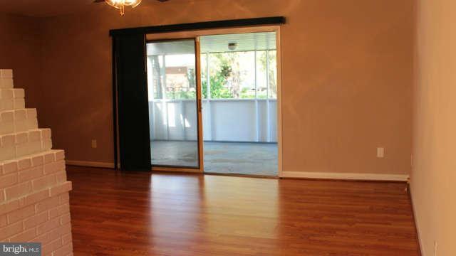 5221 Montgomery Street Springfield, VA 22151 - Photo 4 of 16 a view of an empty room with wooden floor and a window