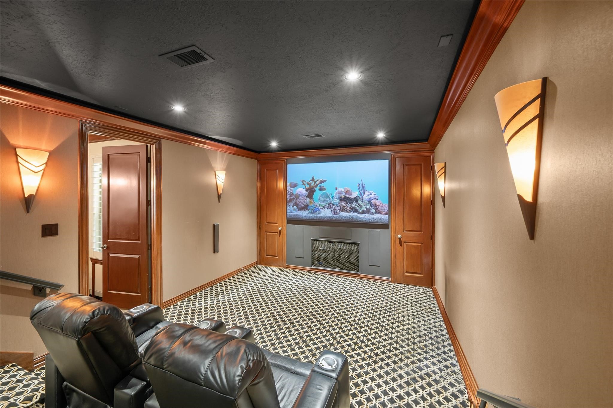 2127 Thicket Ridge Lane Houston, TX 77077 - Photo 18 of 50 The ultimate entertainment hub: experience true immersion with an expansive 101" screen and the unparalleled convenience of direct poolside bath access for effortless transition from movie nights to late-night swims.