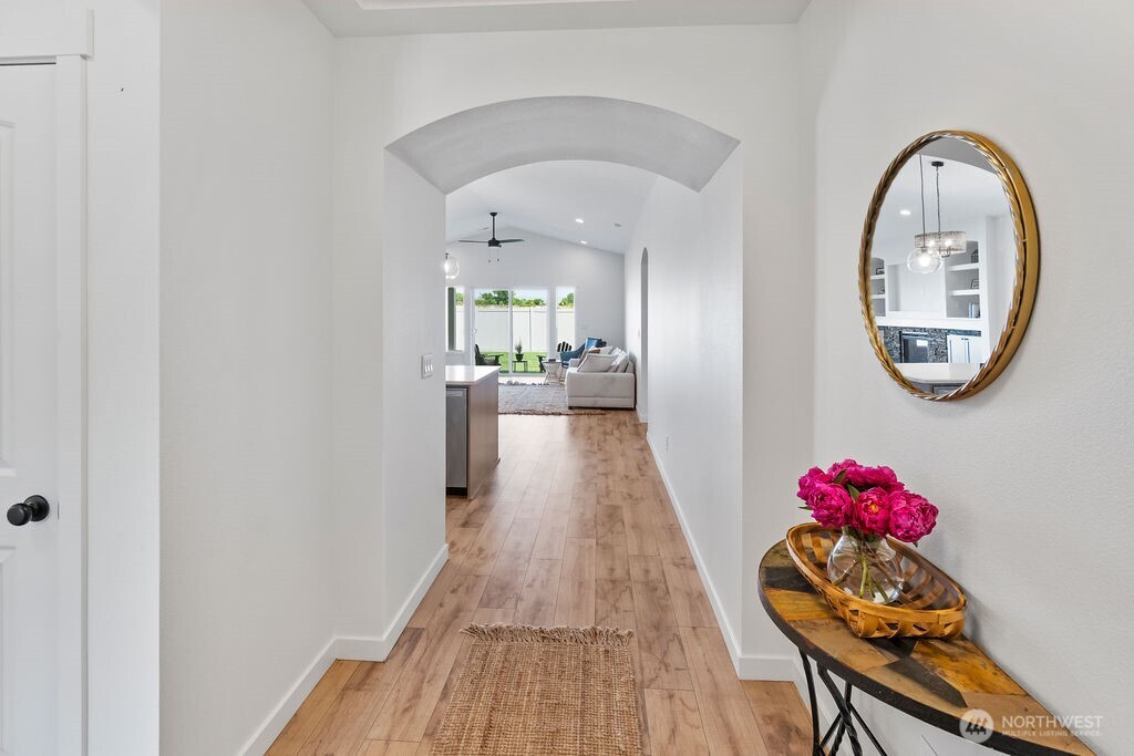231 Shrute Road Prosser, WA 99350 - Photo 23 of 36 a view of a hallway with wooden floor a chandelier and entryway
