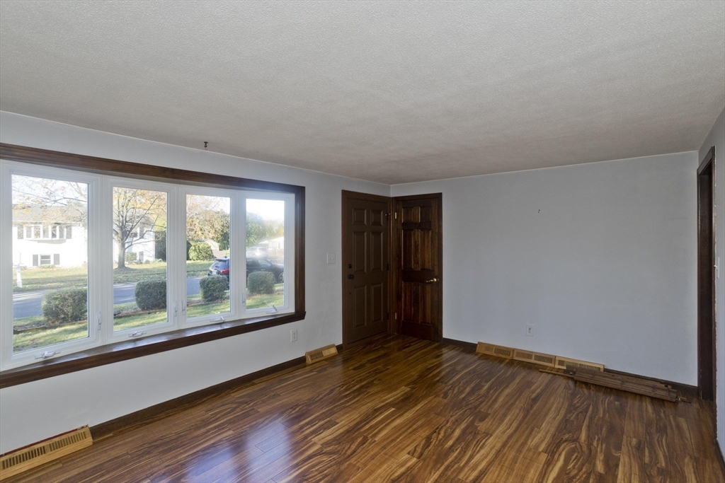 134 Mallard Circle Agawam, MA 01001 - Photo 14 of 36 a view of an empty room with wooden floor and a window