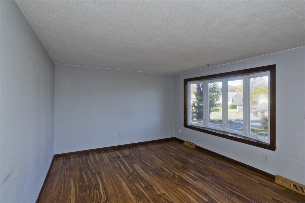 134 Mallard Circle Agawam, MA 01001 - Photo 16 of 36 a view of an empty room with wooden floor and a window