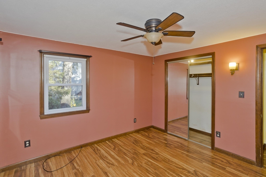 134 Mallard Circle Agawam, MA 01001 - Photo 21 of 36 a view of an empty room with wooden floor and a ceiling fan