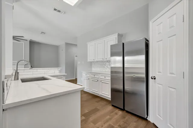 a kitchen with a refrigerator and a sink