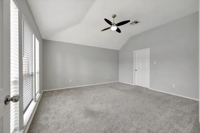 a view of room with a ceiling fan and window