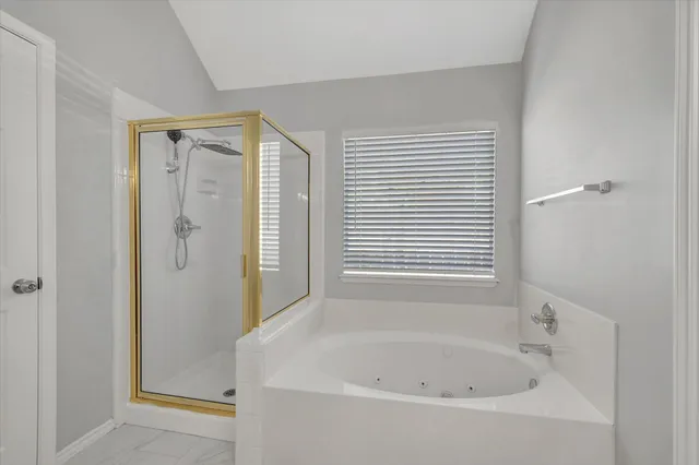 a white bath tub sitting next to a small bathroom