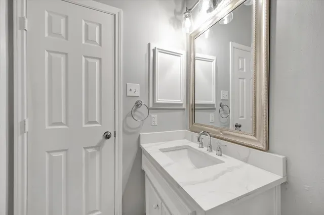 a bathroom with a sink double vanity and a mirror
