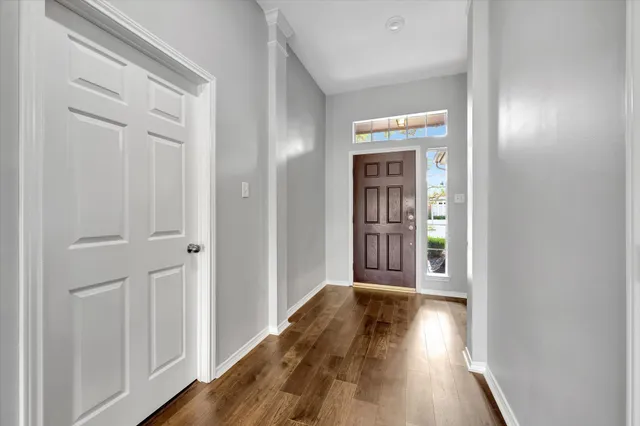 a view of a hallway with wooden floor