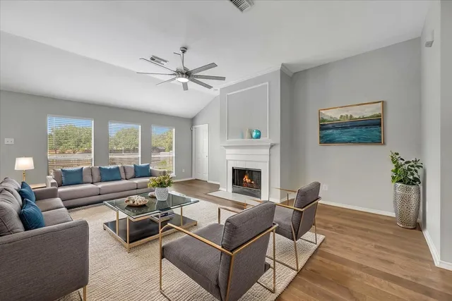 a living room with furniture a table and a fireplace