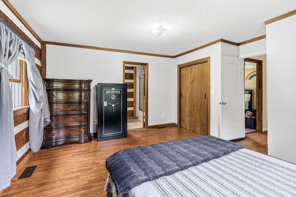 22 Lyon Hill Road Chester, MA 01011 - Photo 21 of 38 a bedroom with a bed and wooden floor