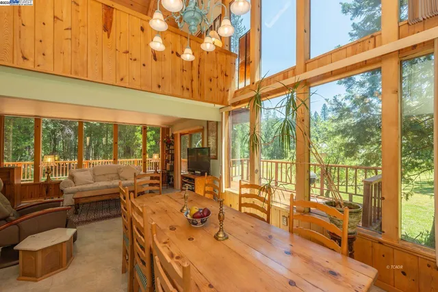 a open kitchen with a stove a refrigerator and a dining table