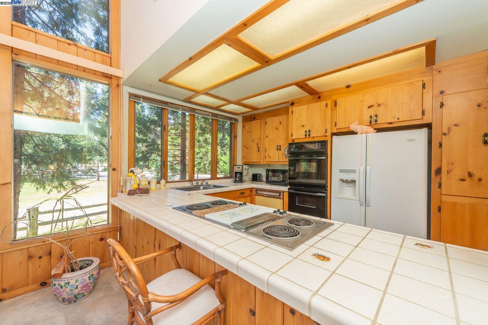 30 Dorleska Court Trinity Center, CA 96091 - Photo 14 of 50 a open kitchen with a stove a refrigerator and a dining table