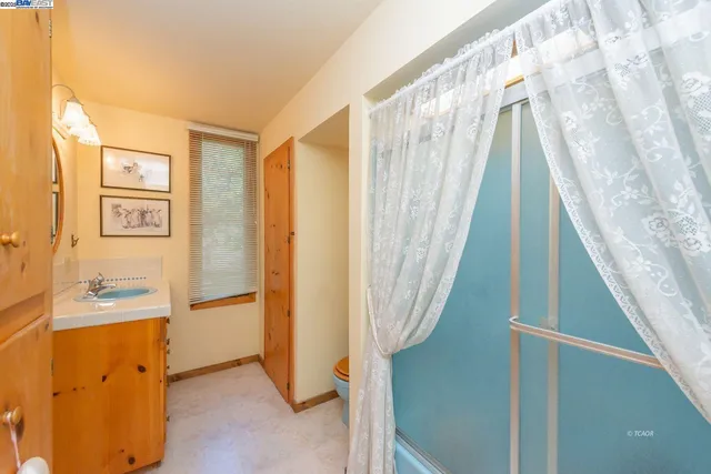a view of a hallway with furniture and a large window