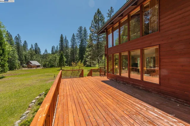 a view of balcony with wooden floor and fence