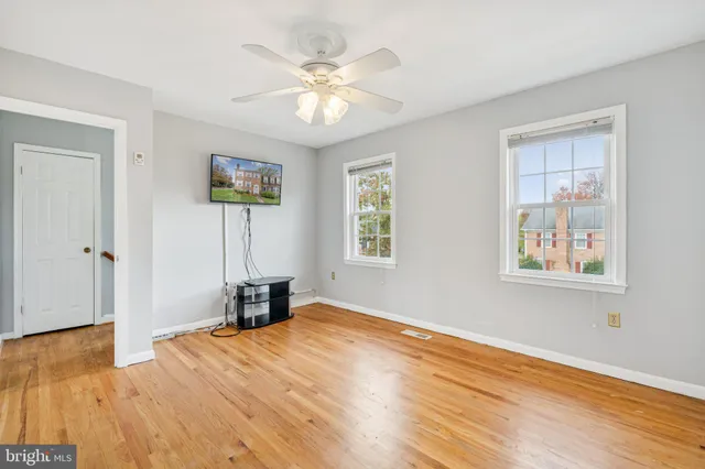 a view of empty room with wooden floor