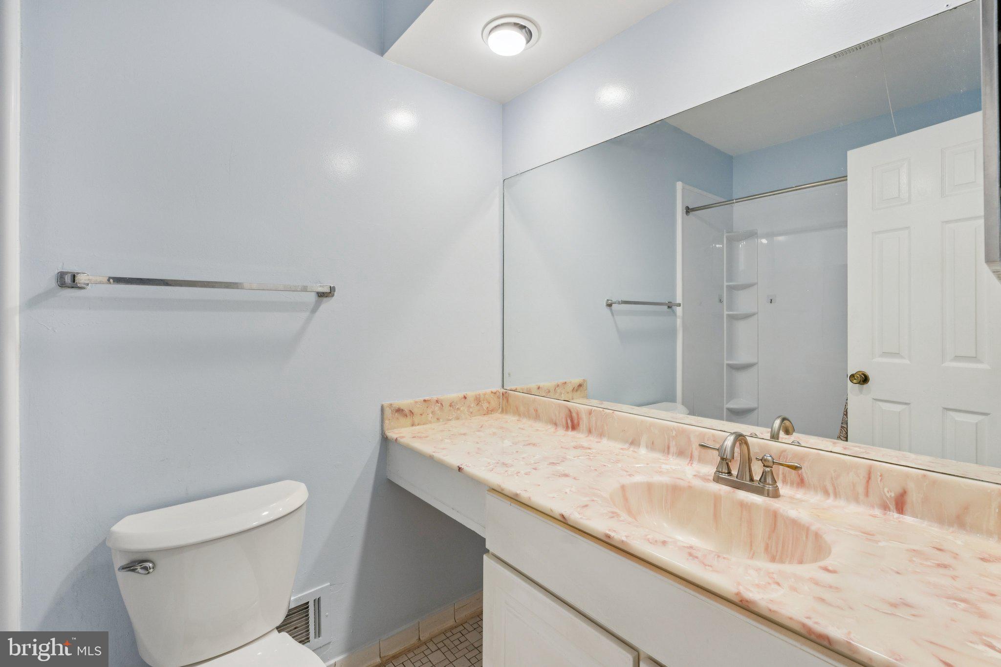 7029 Bradwood Court Springfield, VA 22151 - Photo 21 of 43 a bathroom with a granite countertop sink a toilet and a mirror