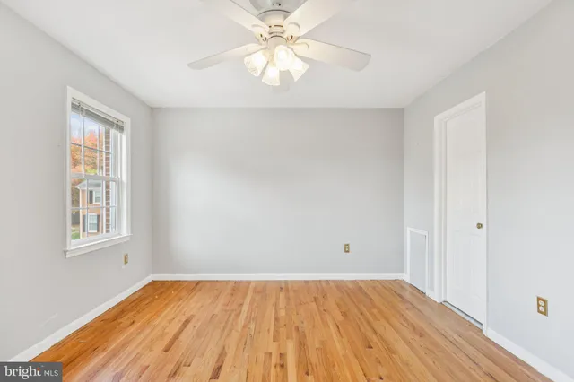wooden floor in an empty room with a window