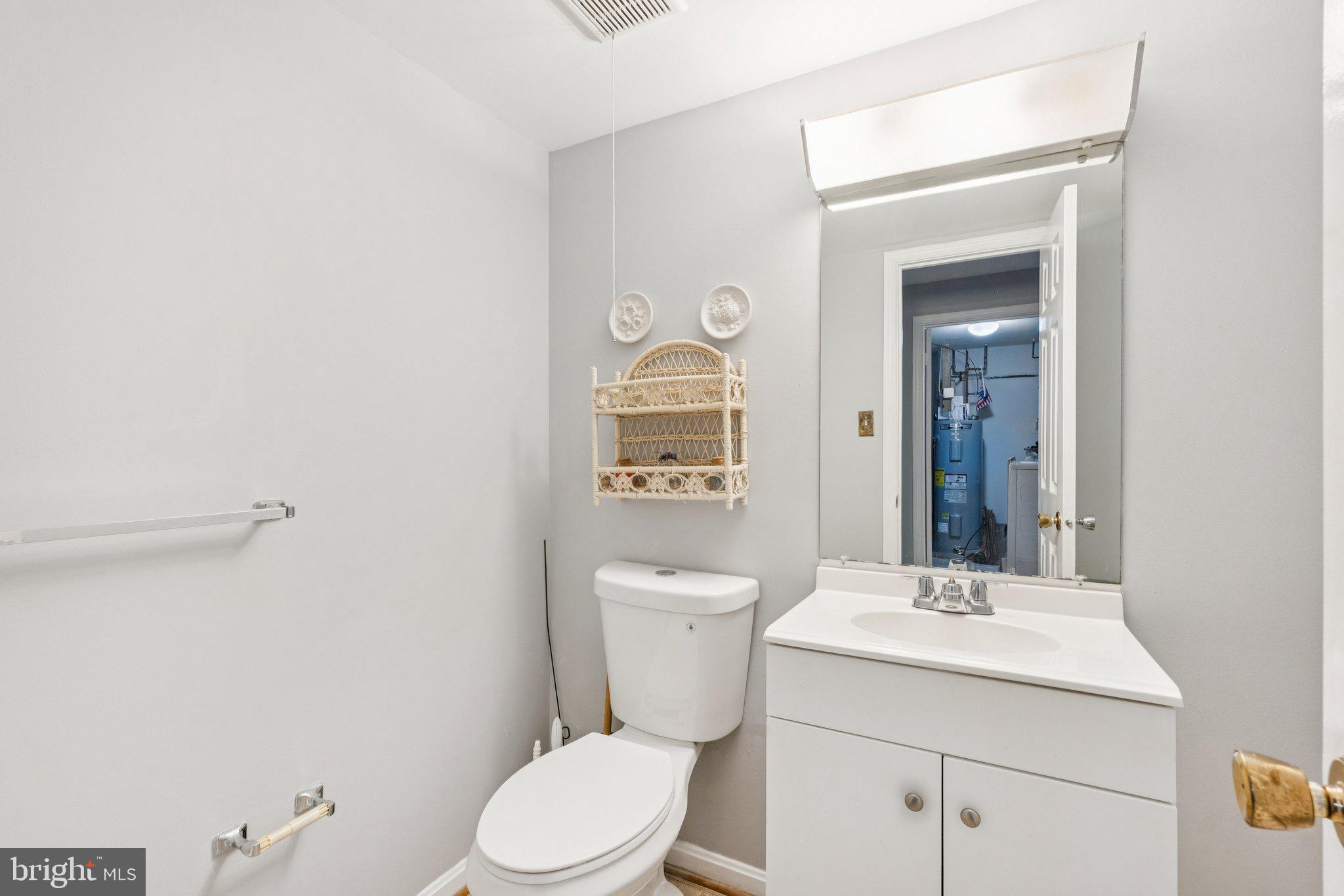 7029 Bradwood Court Springfield, VA 22151 - Photo 34 of 43 a bathroom with a toilet a sink and mirror