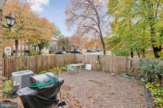 a backyard of a house with table and chairs