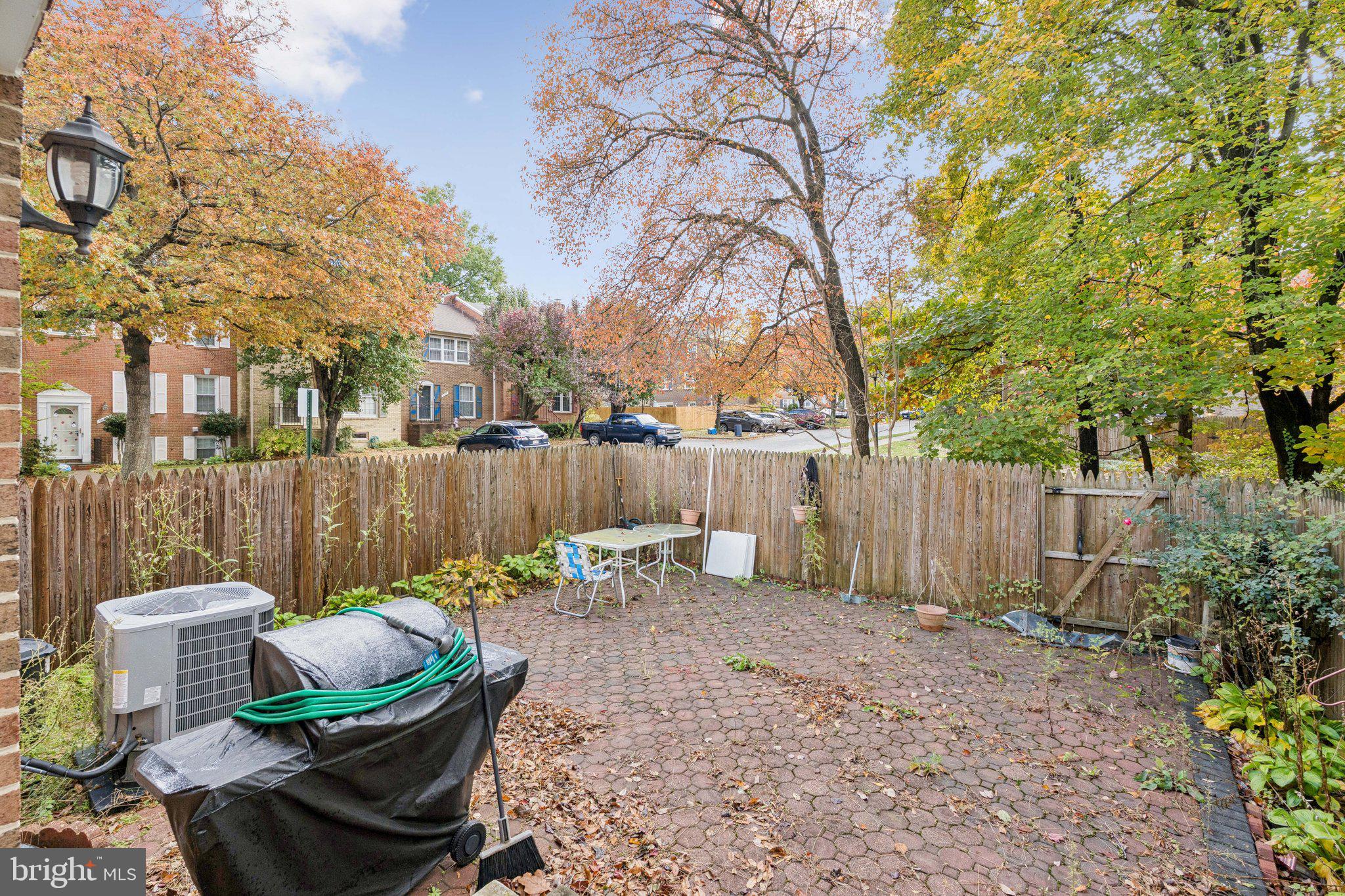7029 Bradwood Court Springfield, VA 22151 - Photo 35 of 43 a backyard of a house with table and chairs